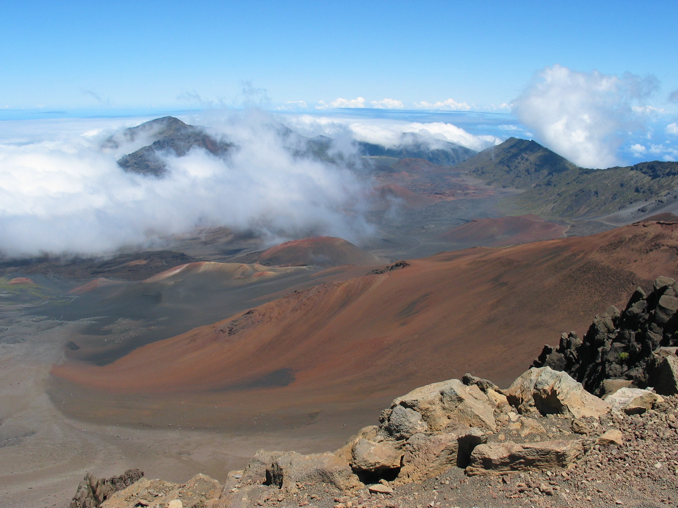 The vast, cone-dotted crater floor of Haleakalā on Maui under a clear sky.